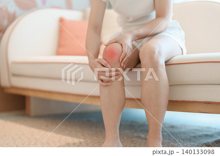 woman having knee ache and muscle pain due to Runners Knee or Patellofemoral Pain Syndrome, osteoarthritis, arthritis, rheumatism and Patellar Tendinitis. health and medical concept 140133098