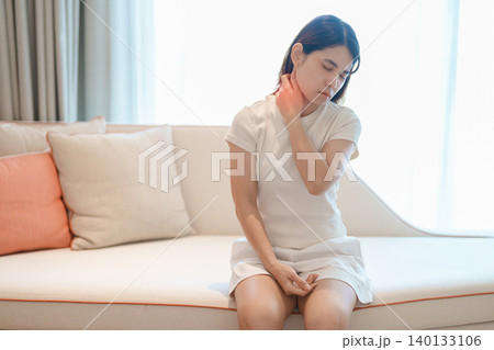 Woman having Neck pain for concepts of Neck Muscle Strain and Inflammation, Myofascial pain syndrome and Fibromyalgia, Rheumatism, Cervical Spine Spondylosis, Office Syndrome and Ergonomic 140133106