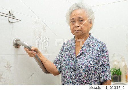 Asian elderly woman use toilet bathroom handle security, healthy strong medical concept. Asian elderly woman use toilet bathroom handle security, healthy strong medical concept. 140133842