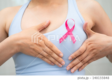 Breast cancer, pink ribbon at Asian senior lady for supporting awareness, symbol of World Breast Cancer Day. Breast cancer, pink ribbon at Asian senior lady for supporting awareness, symbol of World Breast Cancer Day. 140133848