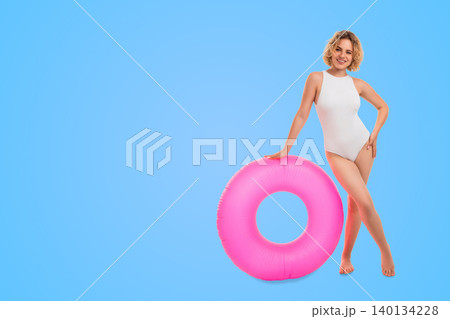 Woman poses with pink float ring. Summer fashion and tropical mood concept 140134228