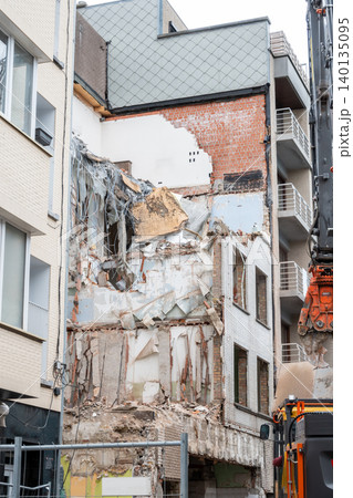 Work during the construction of a building in the city. Destruction of an old building in Germany. Work during the construction of a building in the city. Destruction of an old building in Germany. 140135095