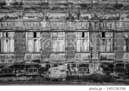 Dilapidated historic brick building with broken windows and crumbling details Dilapidated historic brick building with broken windows and crumbling details 140136396
