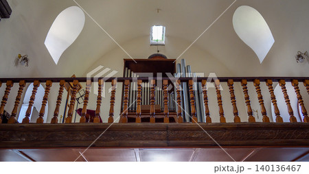 Church balcony featuring detailed woodwork and pipe organ Church balcony featuring detailed woodwork and pipe organ 140136467