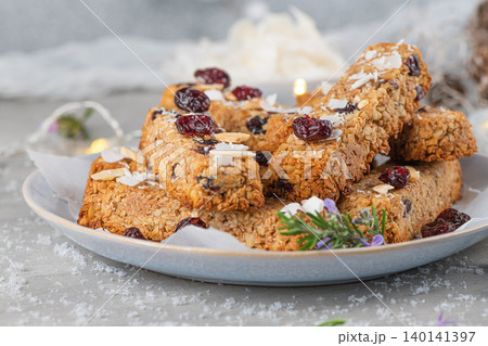 Granola bar. Healthy snack. Cereal granola bar with nuts, fruit, coconut and cranberries on a christmas table Granola bar. Healthy snack. Cereal granola bar with nuts, fruit, coconut and cranberries on a christmas table 140141397