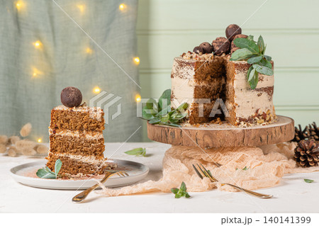 Slice of delicious naked chocolate and hazelnuts cake on table rustic wood kitchen countertop. Slice of delicious naked chocolate and hazelnuts cake on table rustic wood kitchen countertop. 140141399