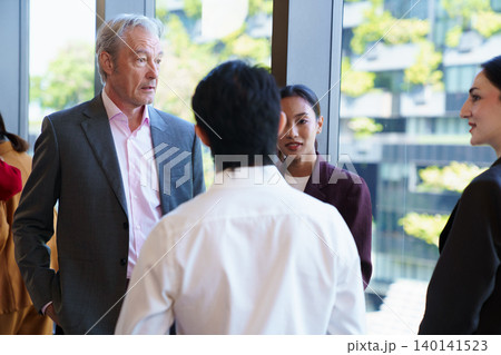 Group of diverse business people talking in modern office Group of diverse business people talking in modern office 140141523