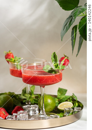 Two strawberry frozen margaritas with lime and mint Two strawberry frozen margaritas with lime and mint 140142246