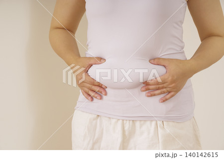 お腹のぜい肉を気にする女性 お腹のぜい肉を気にする女性 140142615