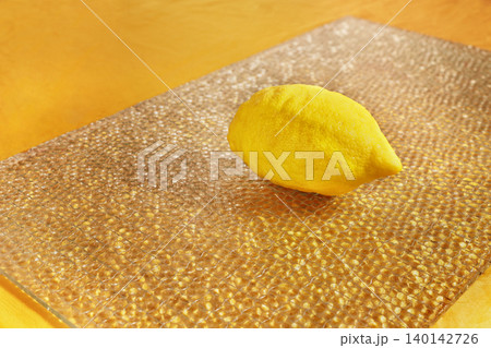 One whole lemon on table 140142726