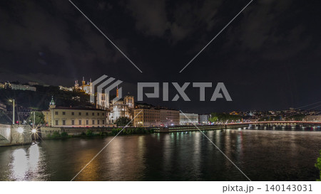 Panorama showing night timelapse of Lyon's cityscape with the red suspension footbridge over the Saone River. France Panorama showing night timelapse of Lyon's cityscape with the red suspension footbridge over the Saone River. France 140143031