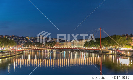 Hyperlapse of the Passerelle du Palais du Justice bridge over the Saone River in Lyon, transition from day to night timelapse. 140143037
