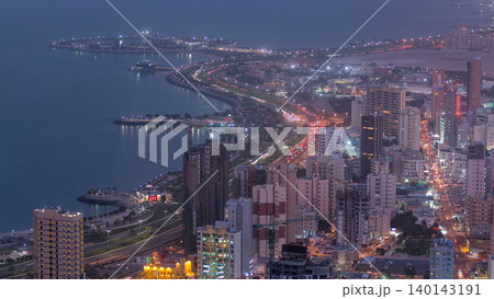 Skyline with Skyscrapers day to night timelapse in Kuwait City downtown illuminated at dusk. Kuwait City, Middle East 140143191