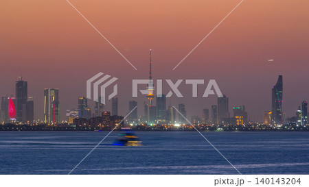 Skyline with Skyscrapers day to night timelapse in Kuwait City downtown illuminated at dusk. Kuwait City, Middle East Skyline with Skyscrapers day to night timelapse in Kuwait City downtown illuminated at dusk. Kuwait City, Middle East 140143204