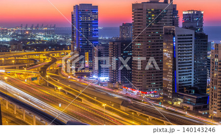 Dubai marina with traffic on sheikh zayed road panorama day to night timelapse lights turn on. Dubai marina with traffic on sheikh zayed road panorama day to night timelapse lights turn on. 140143246