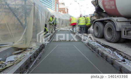 Pouring ready-mixed concrete after placing steel reinforcement to make the road by concrete mixer timelapse hyperlapse. Pouring ready-mixed concrete after placing steel reinforcement to make the road by concrete mixer timelapse hyperlapse. 140143398