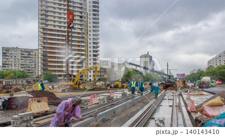 Gray construction telescopic crane unloading tram rails from truck timelapse. 140143410