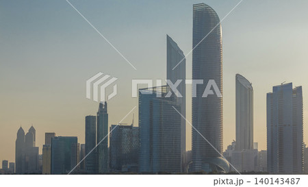 Abu Dhabi city skyline with skyscrapers after sunrise with water reflection timelapse Abu Dhabi city skyline with skyscrapers after sunrise with water reflection timelapse 140143487