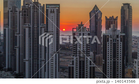 Modern residential and office complex with many towers aerial timelapse at sunset in Business Bay, Dubai, UAE. Modern residential and office complex with many towers aerial timelapse at sunset in Business Bay, Dubai, UAE. 140143566
