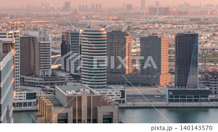 Dubai's business bay towers at evening aerial timelapse. 140143570