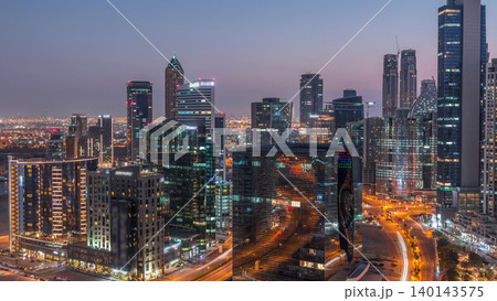 Dubai's business bay towers at evening aerial day to night timelapse. Dubai's business bay towers at evening aerial day to night timelapse. 140143575