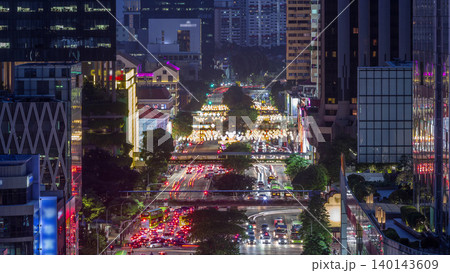Traffic with cars on a street and urban scene in the central district of Singapore day to night timelapse Traffic with cars on a street and urban scene in the central district of Singapore day to night timelapse 140143609