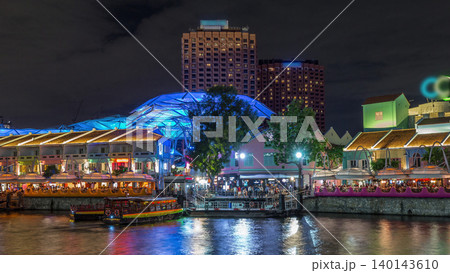 Tourist boats docking at Clarke Quay habour night timelapse hyperlapse. 140143610