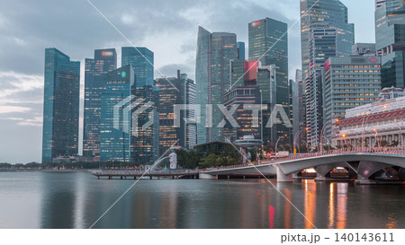 Esplanade bridge and downtown core skyscrapers in the background Singapore night to day timelapse 140143611