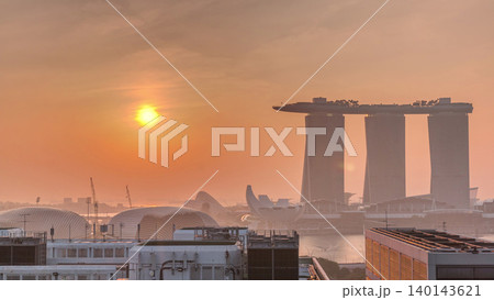 Sunrise near Marina Bay Sands Hotel dominates the skyline at Marina Bay in Singapore aerial timelapse. Sunrise near Marina Bay Sands Hotel dominates the skyline at Marina Bay in Singapore aerial timelapse. 140143621