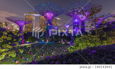 Futuristic aerial view of amazing illumination at Garden by the Bay day to night timelapse in Singapore. 140143641