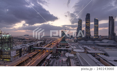 Aerial view of Financial center road night to day timelapse with under construction building Aerial view of Financial center road night to day timelapse with under construction building 140143660