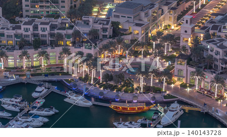 Aerial top view of Dubai Marina day to night timelapse. Modern towers and traffic on the road Aerial top view of Dubai Marina day to night timelapse. Modern towers and traffic on the road 140143728