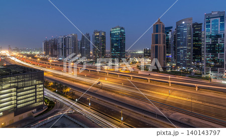 Aerial view of Jumeirah lakes towers skyscrapers day to night timelapse with traffic on sheikh zayed road. Aerial view of Jumeirah lakes towers skyscrapers day to night timelapse with traffic on sheikh zayed road. 140143797