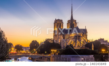 Rear view of Notre Dame De Paris cathedral day to night timelapse after sunset. Rear view of Notre Dame De Paris cathedral day to night timelapse after sunset. 140143849
