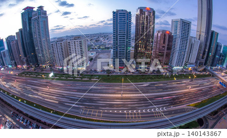 Downtown Dubai towers day to night timelapse. Aerial view of Sheikh Zayed road with skyscrapers after sunset. Downtown Dubai towers day to night timelapse. Aerial view of Sheikh Zayed road with skyscrapers after sunset. 140143867