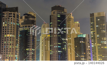 Evening Dubai marina city center with floating vessels day to night timelapse 140144026