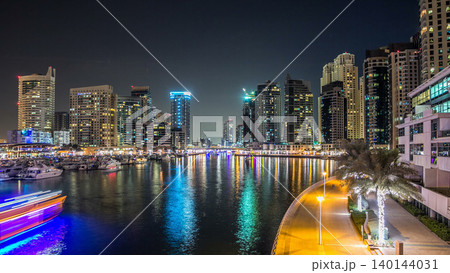 Dubai Marina towers and yachts in Dubai at night timelapse hyperlapse 140144031