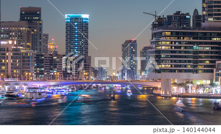 Dubai Marina towers and canal in Dubai day to night timelapse Dubai Marina towers and canal in Dubai day to night timelapse 140144044