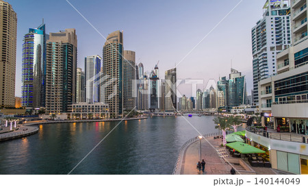 Dubai Marina towers and canal in Dubai day to night timelapse 140144049