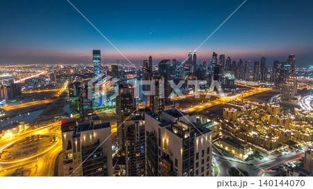 Aerial view of a big modern city day to night timelapse. Business bay, Dubai, United Arab Emirates. 140144070
