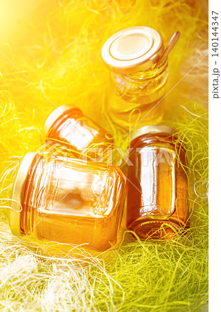 Natural honey in various jars on a wooden shelf, souvenir village market. Natural honey in various jars on a wooden shelf, souvenir village market. 140144347