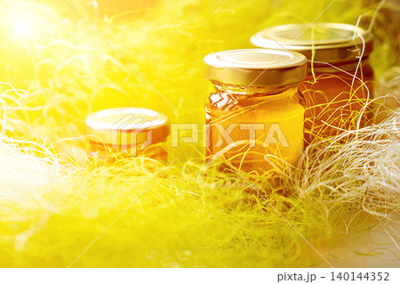 Selective focus. Linden honey in a jar. Leaves and flowers of linden. Freshly linden honey. Selective focus. Linden honey in a jar. Leaves and flowers of linden. Freshly linden honey. 140144352