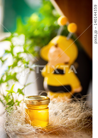 Natural honey in various jars on a wooden shelf, souvenir village market. Natural honey in various jars on a wooden shelf, souvenir village market. 140144359