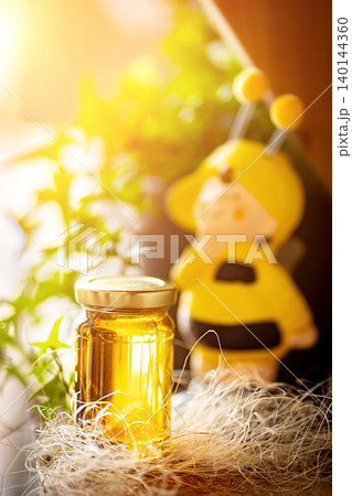 Natural honey in various jars on a wooden shelf, souvenir village market. Natural honey in various jars on a wooden shelf, souvenir village market. 140144360