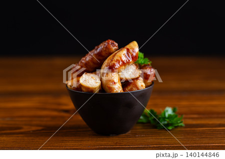 roasted meat sausages on dark background closeup scene roasted meat sausages on dark background closeup scene 140144846