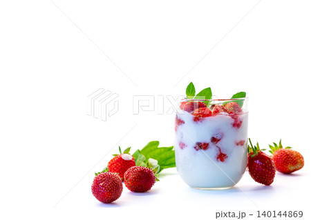 Summer berry dessert in glass on white backdrop Summer berry dessert in glass on white backdrop 140144869