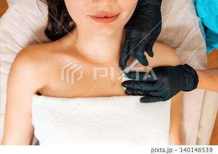 Professional beautician makes an injection of hialuronic acid at breast of client's. Close up. Top view. Concept of plastic surgery Professional beautician makes an injection of hialuronic acid at breast of client's. Close up. Top view. Concept of plastic surgery 140146539