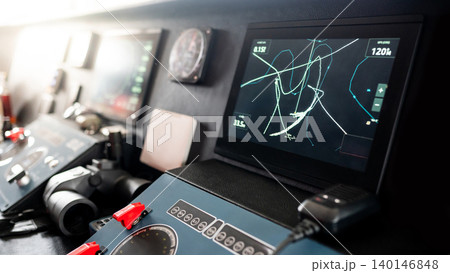 Digital GPS navigation monitor with VHF Radio, marine radar and binoculars on boat dashboard 140146848