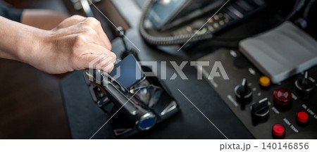 Captain hand holding throttle control or engine control lever on boat dashboard 140146856