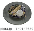 Isolated on a white background, this Japanese set meal is presented on a round tabletop. A deep-blue patterned plate holds a grilled, golden-brown fish fillet, a rounded mound of white rice, and a 140147689